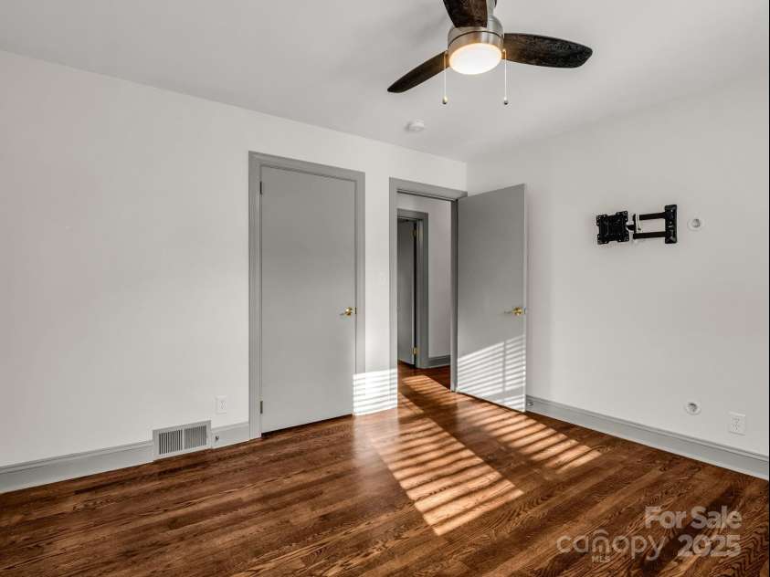 2115 Stoney View Court, Hendersonville, NC 28792.  MLS# CAR4310001, YatesRealty ID 839. Beautifully updated guest bedrooms with timeless hardwood floors, ample natural light, and a neutral design