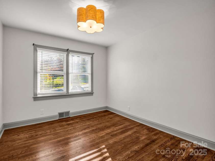 2115 Stoney View Court, Hendersonville, NC 28792.  MLS# CAR4310001, YatesRealty ID 839. Beautifully updated guest bedrooms with timeless hardwood floors, ample natural light, and a neutral design