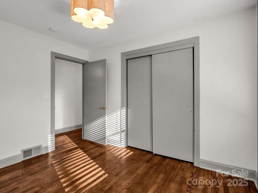 2115 Stoney View Court, Hendersonville, NC 28792.  MLS# CAR4310001, YatesRealty ID 839. Beautifully updated guest bedrooms with timeless hardwood floors, ample natural light, and a neutral design