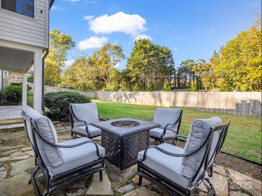 2115 Stoney View Court, Hendersonville, NC 28792.  MLS# CAR4310001, YatesRealty ID 839. Enjoy the outdoors in this private, fenced backyard featuring a beautiful stone patio and cozy fire pit seating