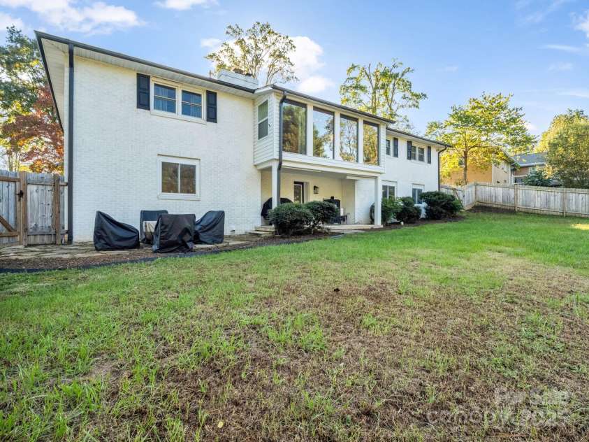 2115 Stoney View Court, Hendersonville, NC 28792.  MLS# CAR4310001, YatesRealty ID 839. Spacious fenced backyard with a covered patio and large windows that fill the home with natural light — perfect for outdoor entertaining or quiet evenings