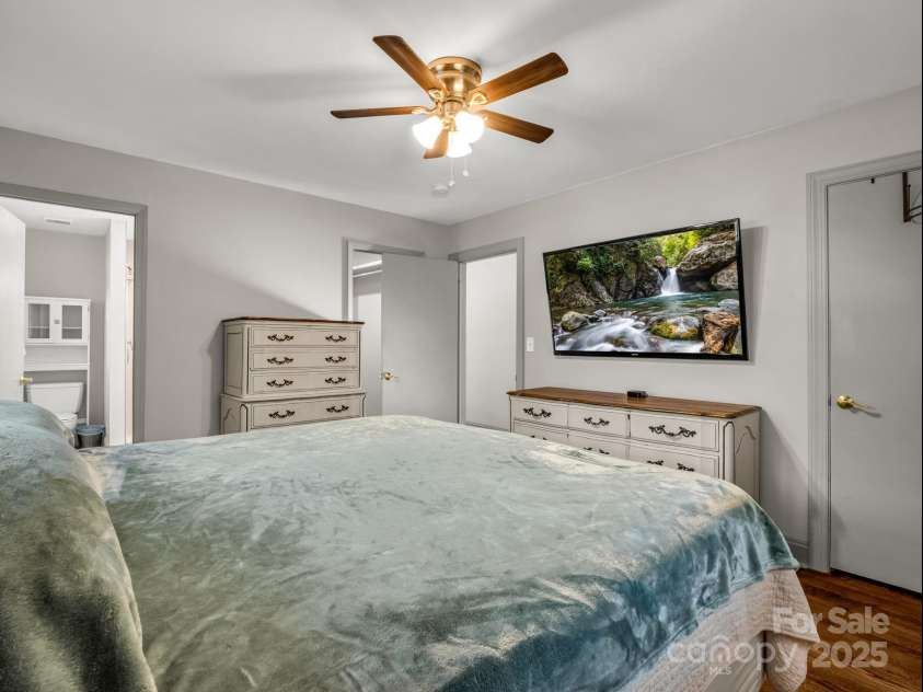 2115 Stoney View Court, Hendersonville, NC 28792.  MLS# CAR4310001, YatesRealty ID 839. Spacious primary suite featuring warm hardwood floors, neutral tones, and an inviting layout with an en-suite bath and generous walk-in closet