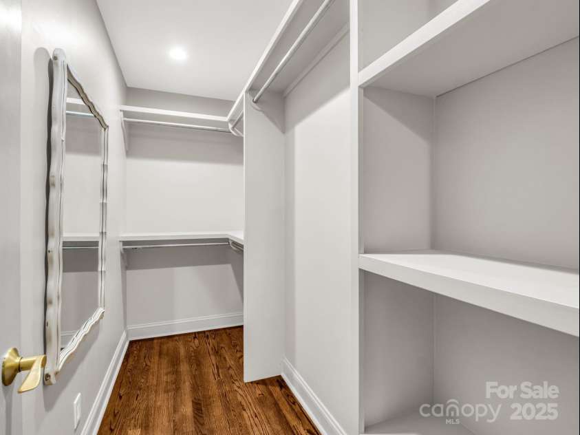 2115 Stoney View Court, Hendersonville, NC 28792.  MLS# CAR4310001, YatesRealty ID 839. Spacious primary suite featuring warm hardwood floors, neutral tones, and an inviting layout with an en-suite bath and generous walk-in closet