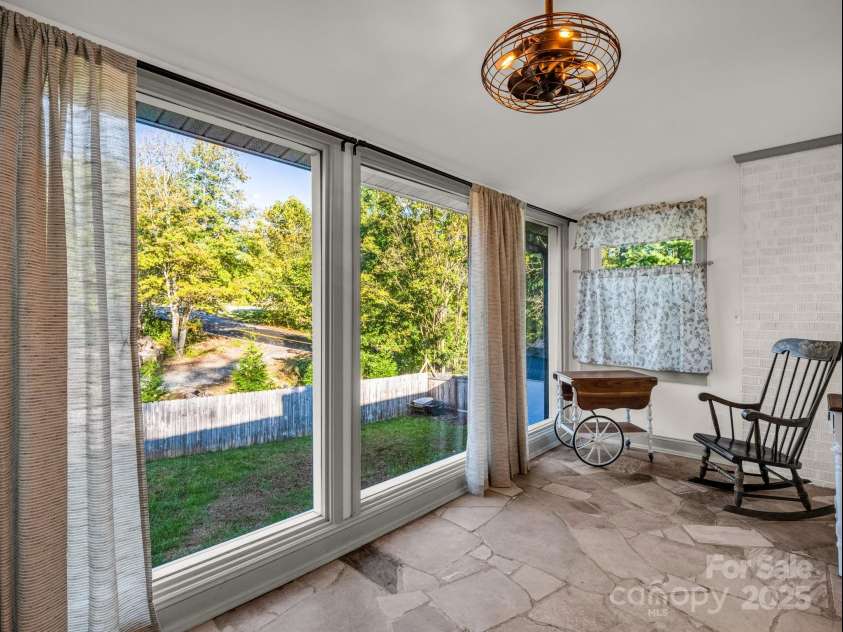 2115 Stoney View Court, Hendersonville, NC 28792.  MLS# CAR4310001, YatesRealty ID 839. Sunlit sitting room, featuring floor-to-ceiling windows, natural stone flooring