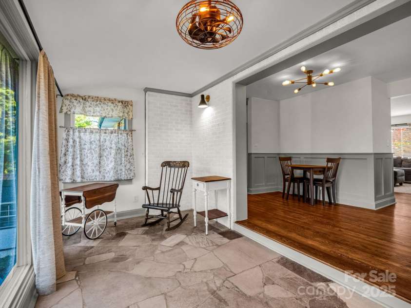 2115 Stoney View Court, Hendersonville, NC 28792.  MLS# CAR4310001, YatesRealty ID 839. Sunlit sitting room, featuring floor-to-ceiling windows, natural stone flooring