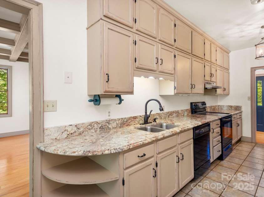 116 Sams Branch Road, Candler, NC 28715.  MLS# CAR4137587, YatesRealty ID 8417. Galley kitchen with Custom cabinets to the ceiling