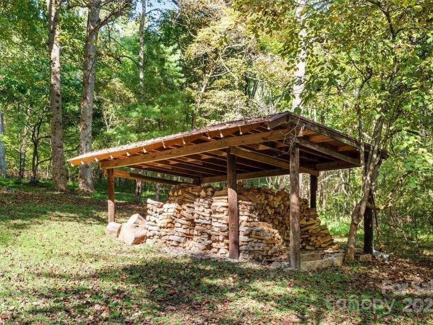 116 Sams Branch Road, Candler, NC 28715.  MLS# CAR4137587, YatesRealty ID 8417. Wood storage on property