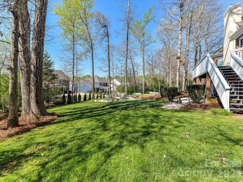1320 Hudson Place, Davidson, NC 28036.  MLS# CAR4360257, YatesRealty ID 8419. Large backyard with mature landscaping