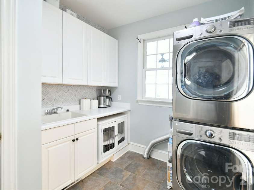 1320 Hudson Place, Davidson, NC 28036.  MLS# CAR4360257, YatesRealty ID 8419. Large laundry room with sink and cabinetry