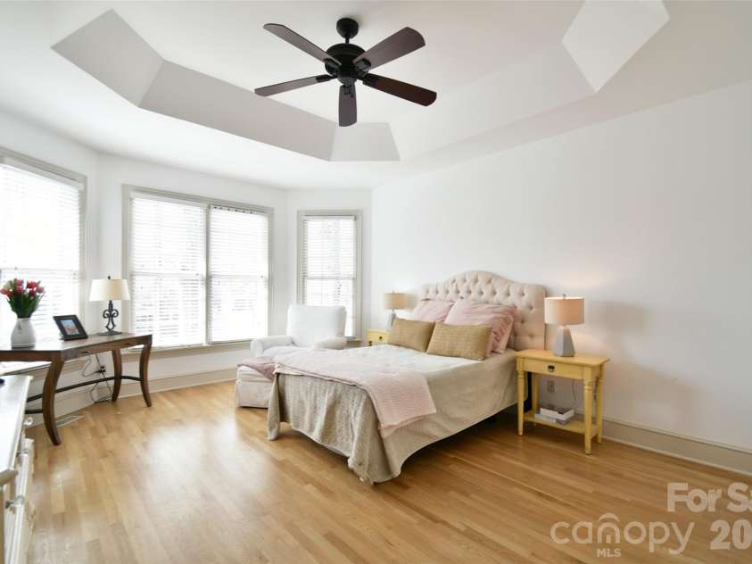 1320 Hudson Place, Davidson, NC 28036.  MLS# CAR4360257, YatesRealty ID 8419. Serene primary bedroom on the main level with bay windows and trey ceiling