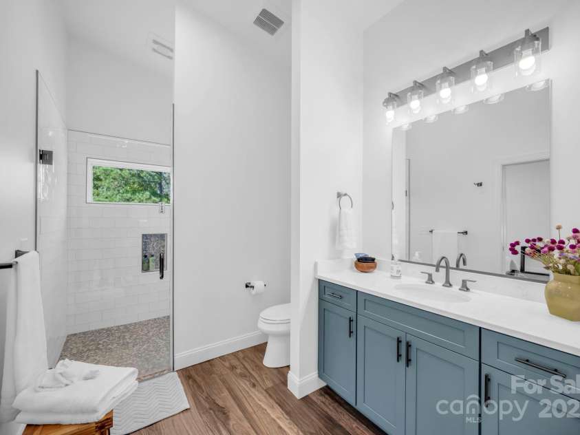 1260 Beaver Island Trail Road, Walnut Cove, NC 27052.  MLS# CAR4325171, YatesRealty ID 843. Full bathroom w/ frameless glass shower & tile surround, large vanity, and quartz countertop