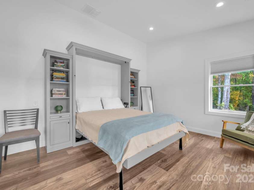 1260 Beaver Island Trail Road, Walnut Cove, NC 27052.  MLS# CAR4325171, YatesRealty ID 843. Guest bedroom w/ Murphy bed w/ built in cabinet and display shelves