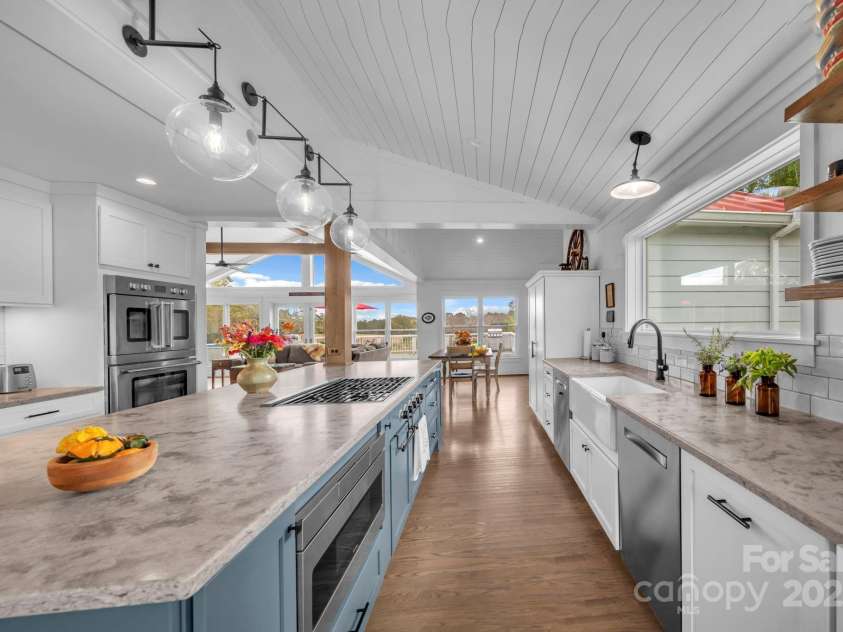 1260 Beaver Island Trail Road, Walnut Cove, NC 27052.  MLS# CAR4325171, YatesRealty ID 843. Honed quartz countertop, tile backsplash, farmhouse porcelain sink, & glass globe pendant light fixtures