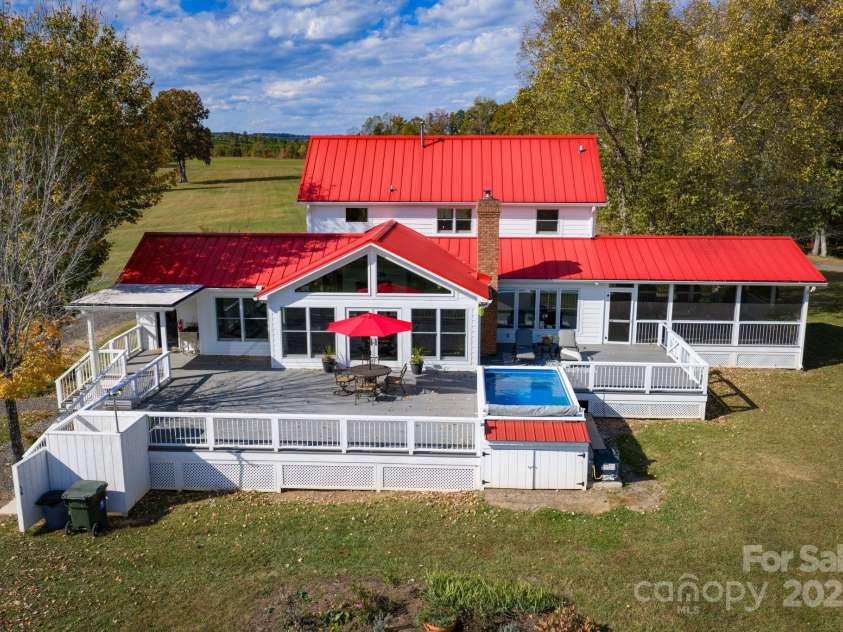 1260 Beaver Island Trail Road, Walnut Cove, NC 27052.  MLS# CAR4325171, YatesRealty ID 843. Large Trex style back deck, endless lap style pool (HydroDrive System), outdoor shower, direct access from the mudroom or great room, and views of rolling pasture and ponds
