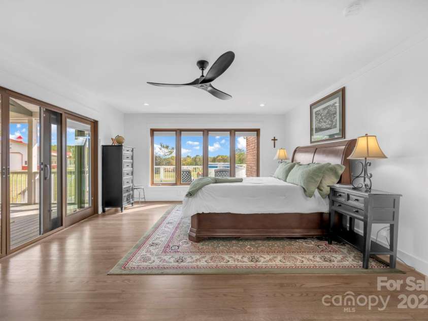 1260 Beaver Island Trail Road, Walnut Cove, NC 27052.  MLS# CAR4325171, YatesRealty ID 843. Primary bedroom w/ ceiling fan and direct access to the screen porch