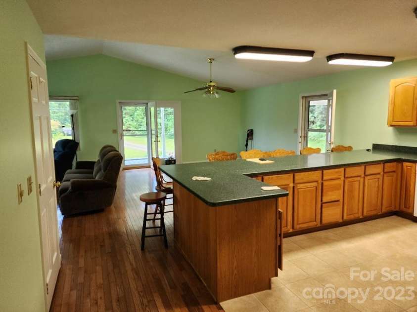 160 Snake Den Drive, Burnsville, NC 28714.  MLS# CAR4062924, YatesRealty ID 843. From kitchen looking into dining area