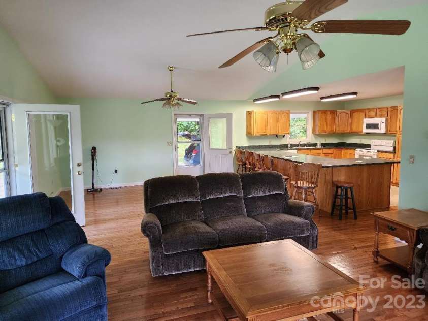 160 Snake Den Drive, Burnsville, NC 28714.  MLS# CAR4062924, YatesRealty ID 843. From living room area looking to dining and kitchen