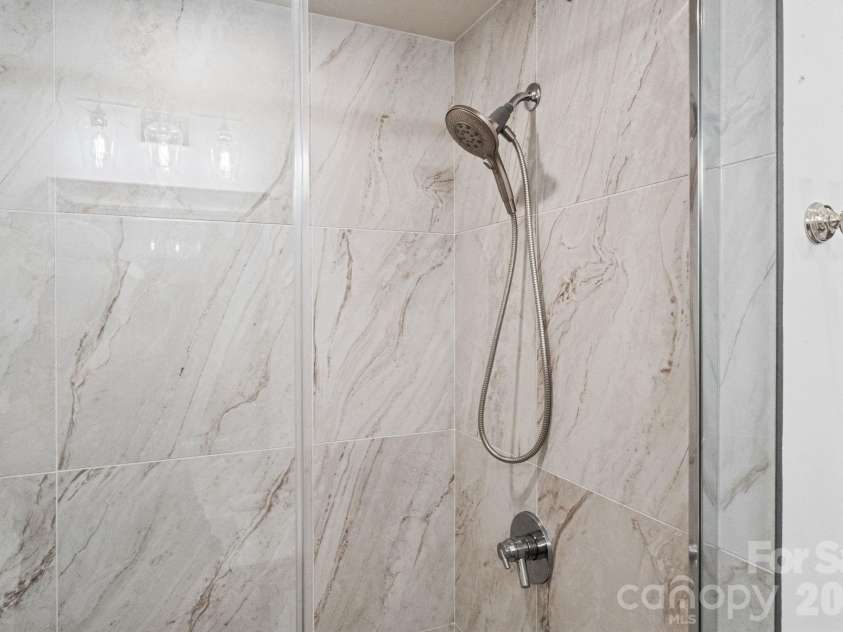 13212 Oak Farm Lane, Huntersville, NC 28078.  MLS# CAR4392191, YatesRealty ID 8431. Elegant tilework and quality finishes elevate the space while creating a spa-like feel.