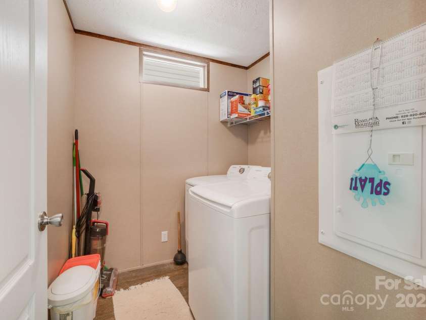 4825 Cane Creek Road, Bakersville, NC 28705.  MLS# CAR4248421, YatesRealty ID 8433. Laundry room off kitchen/primary bedroom