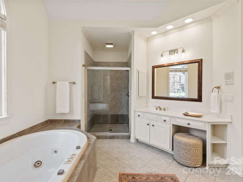 5809 Woodleigh Oaks Drive, Charlotte, NC 28226.  MLS# CAR4248176, YatesRealty ID 8441. Large Primary Bath with glass shower enclosure and soaking tub...