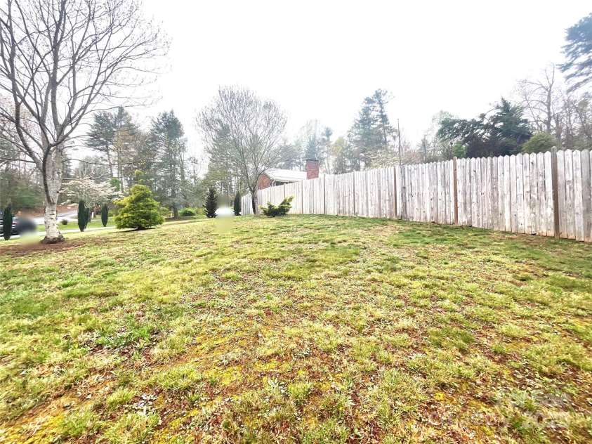 328 Melody Lane, Saluda, NC 28773.  MLS# CAR4282842, YatesRealty ID 8455. Side yard