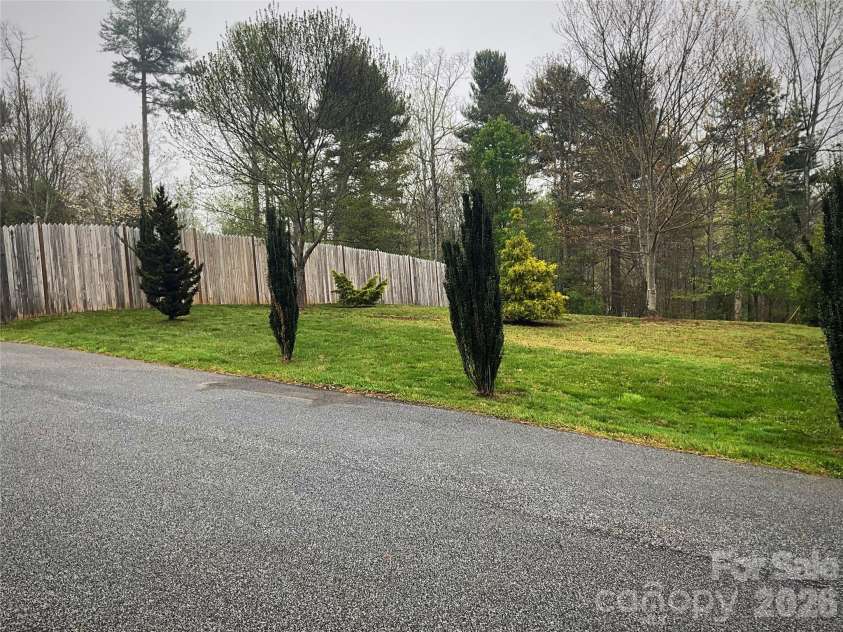 328 Melody Lane, Saluda, NC 28773.  MLS# CAR4282842, YatesRealty ID 8455. Side yard