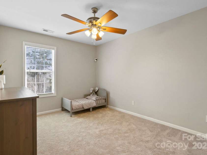 5622 Dartington Drive, Indian Land, SC 29707.  MLS# CAR4241040, YatesRealty ID 8456. The secondary bedroom is roomy, with a ceiling fan