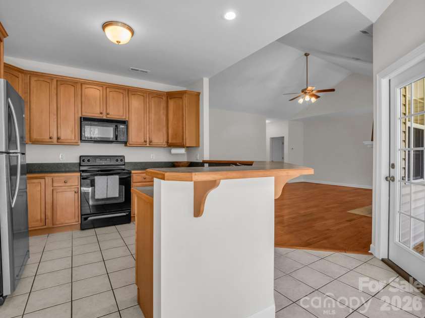 7 Saint Andrews Road, Arden, NC 28704.  MLS# CAR4304401, YatesRealty ID 8462. Kitchen with access to back porch.