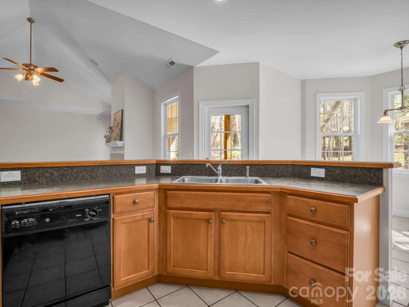 7 Saint Andrews Road, Arden, NC 28704.  MLS# CAR4304401, YatesRealty ID 8462. Kitchen with warm wood cabinets.