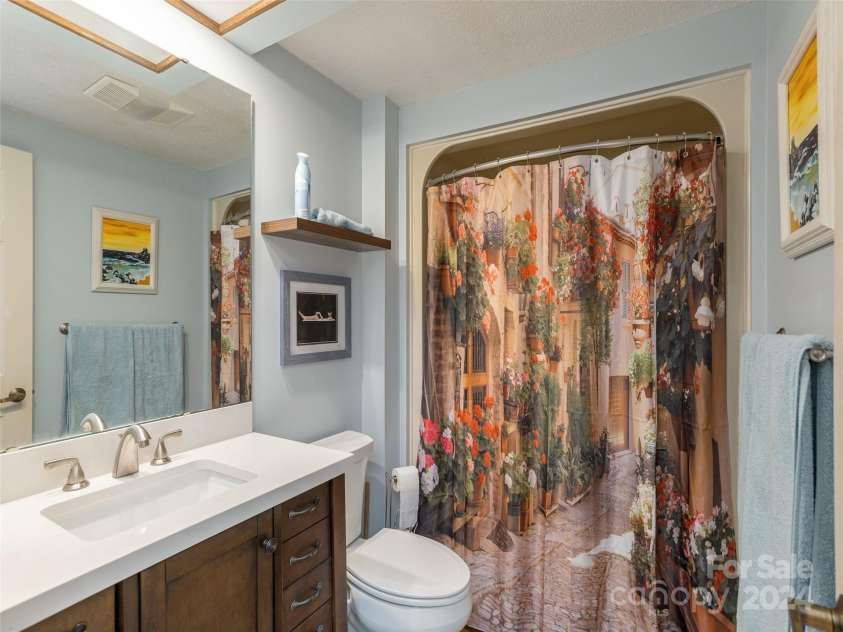 303 White Oak Drive, Hendersonville, NC 28791.  MLS# CAR4186920, YatesRealty ID 8475. Partially remodeled guest bathroom off the guest bedroom. Provides privacy for overnight guests.