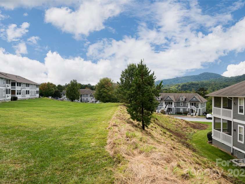 4805 Breakers Lane, Asheville, NC 28806.  MLS# CAR4307390, YatesRealty ID 848. Back green area.