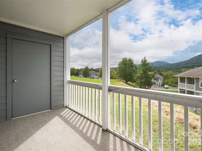 4805 Breakers Lane, Asheville, NC 28806.  MLS# CAR4307390, YatesRealty ID 848. Screened-in back porch, sitting area with long-range views and a storage closet.