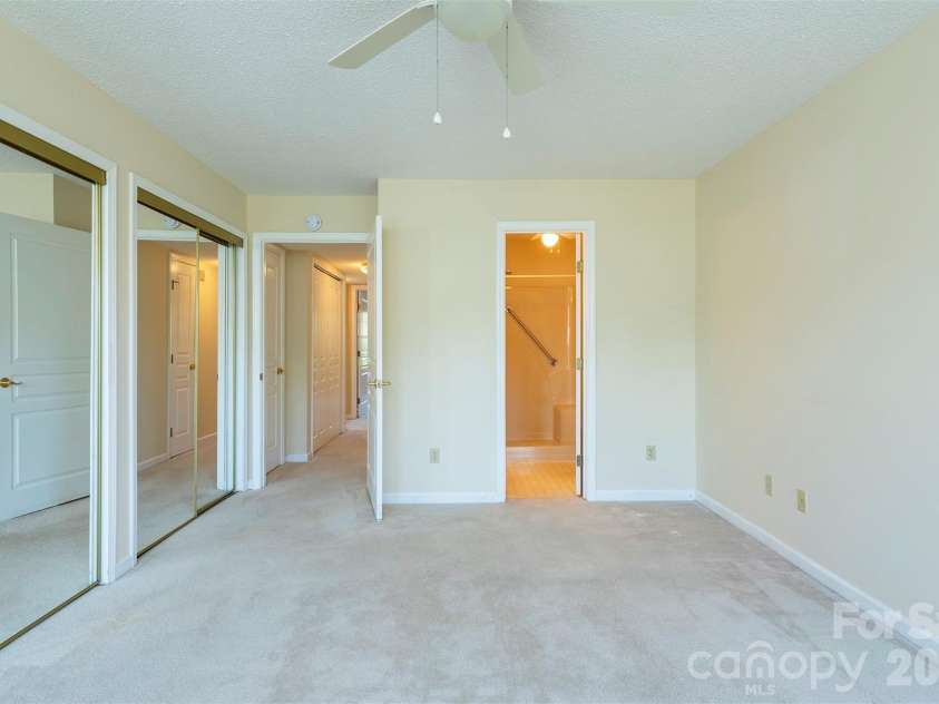 4805 Breakers Lane, Asheville, NC 28806.  MLS# CAR4376162, YatesRealty ID 848. The primary bedroom, the hallway and the primary bath.