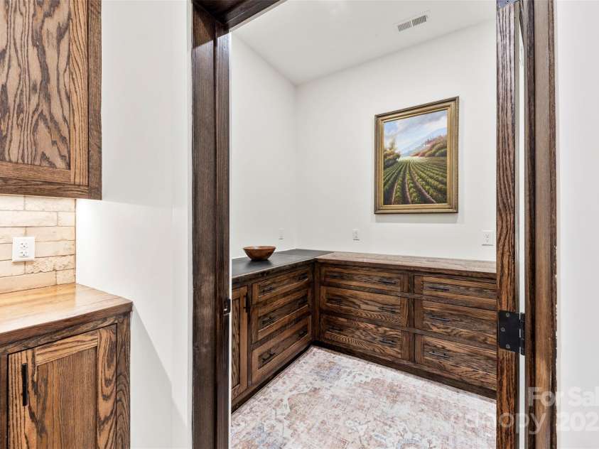 13124 Lemmond Drive, Matthews, NC 28105.  MLS# CAR4228308, YatesRealty ID 8482. Pantry with built in oak cabinets
