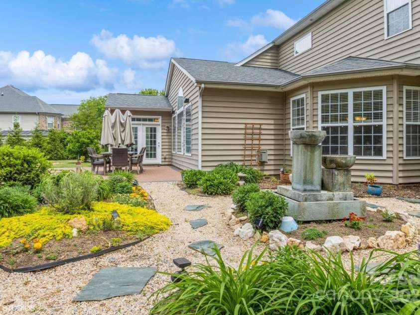 10012 Royal Colony Drive, Waxhaw, NC 28173.  MLS# CAR4250222, YatesRealty ID 8489. Beautiful flower garden with fountain