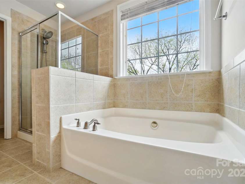 3619 Grove Creek Pond Drive, Concord, NC 28027.  MLS# CAR4244273, YatesRealty ID 8492. Primary bath soaking tub and separate shower.