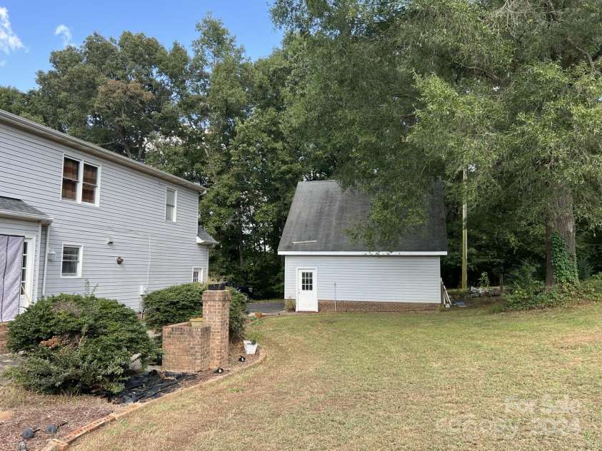 331 Polk Ford Road, Stanfield, NC 28163.  MLS# CAR4174696, YatesRealty ID 850. Backyard view of masonry grill and detached garage
