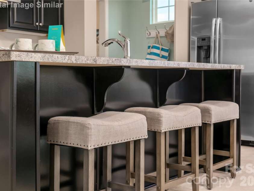 2063 Fernway Drive, Charlotte, NC 28216.  MLS# CAR4352688, YatesRealty ID 8505. Island seating for three — perfect for pancakes, pep talks, and plotting your next dinner party!
