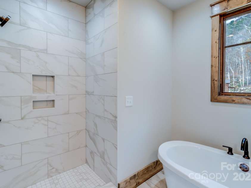 37 Tioga Trail, Banner Elk, NC 28604.  MLS# CAR4215738, YatesRealty ID 852. Walk in shower in primary bathroom