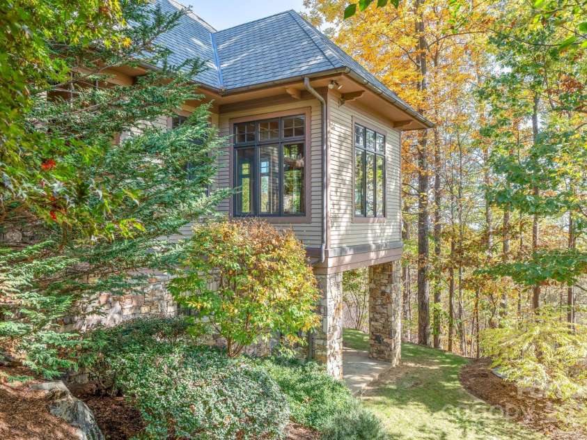 150 Cherry Hill, Mill Spring, NC 28756.  MLS# CAR4201746, YatesRealty ID 8524. Coming around the side of the house you will notice the well planned landscaping giving every room a great view.  