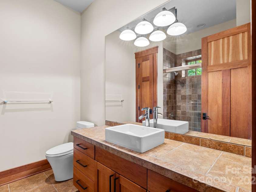 150 Cherry Hill, Mill Spring, NC 28756.  MLS# CAR4201746, YatesRealty ID 8524. Full bath in lower level with quality finishes and more solid cherry custom cabinetry. There is also a half bath on this level and a home office, den and bonus room.