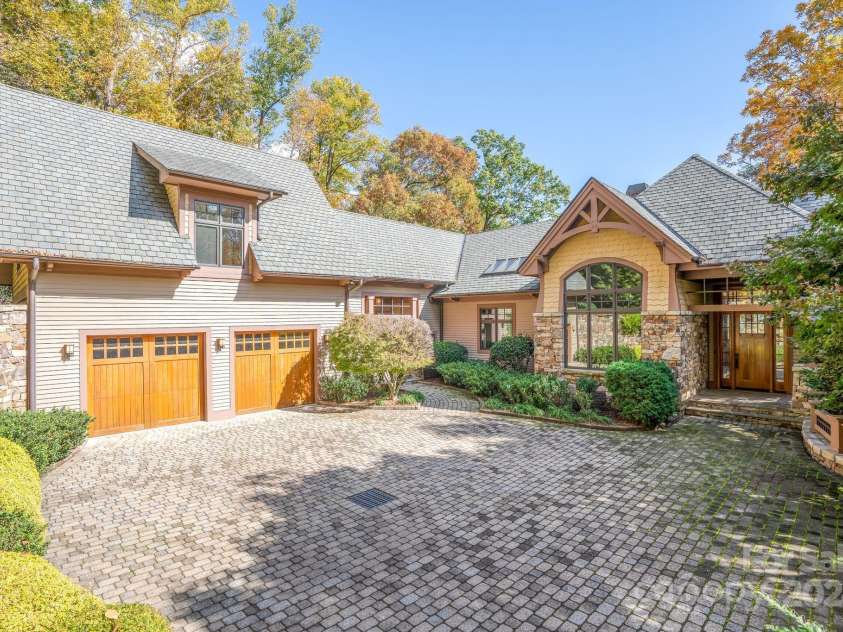 150 Cherry Hill, Mill Spring, NC 28756.  MLS# CAR4201746, YatesRealty ID 8524. Lovely courtyard area with cobblestone style pavers welcomes you and offers ample guest parking and garage space.