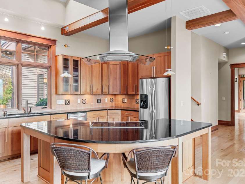 150 Cherry Hill, Mill Spring, NC 28756.  MLS# CAR4201746, YatesRealty ID 8524. Note the beautiful ceiling beams.  Tucked behind the kitchen are wide stairs up to a bedroom suite with a full bath and private sitting room. Perfect for guests! 