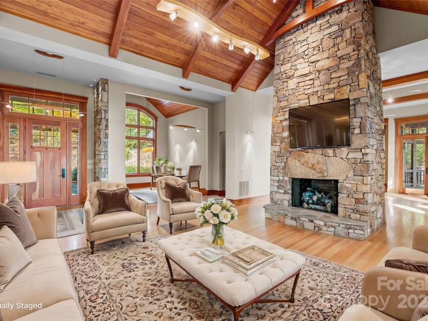 150 Cherry Hill, Mill Spring, NC 28756.  MLS# CAR4201746, YatesRealty ID 8524. Soaring ceilings and a stunning stone fireplace make this living room special.