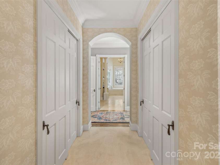 250 Big Bear Road, Highlands, NC 28741.  MLS# CAR4313436, YatesRealty ID 8529. Hallway from Primary Suite to Primary Bath