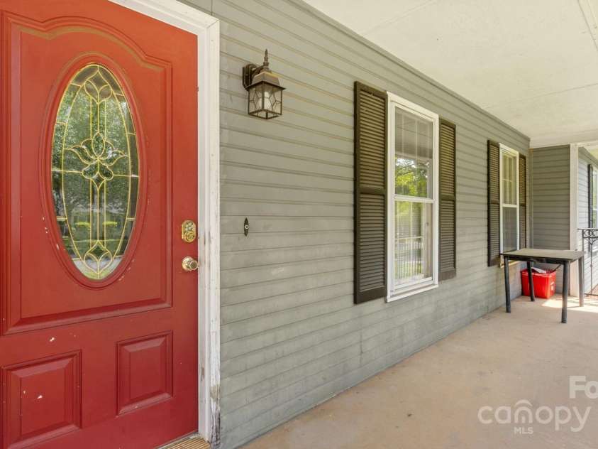 6915 Norchester Court, Charlotte, NC 28227.  MLS# CAR4250063, YatesRealty ID 8539. Broad, covered front porch perfect for relaxing