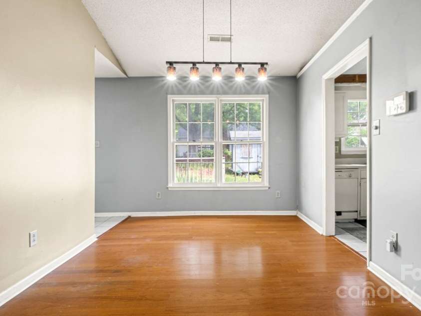 6915 Norchester Court, Charlotte, NC 28227.  MLS# CAR4250063, YatesRealty ID 8539. Dining room has great condition hardwoods floowing through