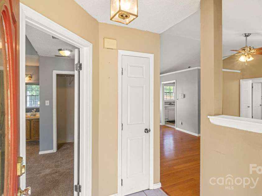 6915 Norchester Court, Charlotte, NC 28227.  MLS# CAR4250063, YatesRealty ID 8539. Entry leads from primary suite on left front to living/dining. Ideal split floor plan