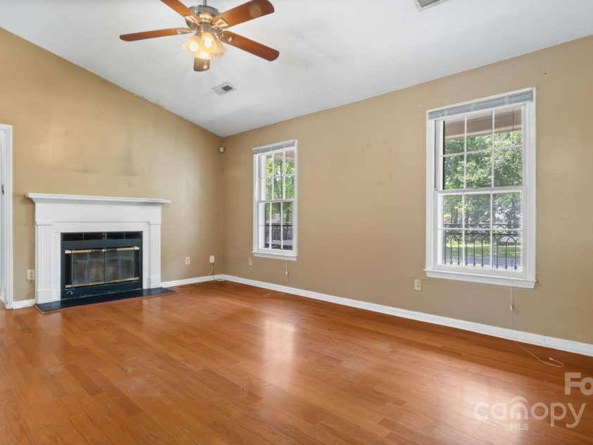 6915 Norchester Court, Charlotte, NC 28227.  MLS# CAR4250063, YatesRealty ID 8539. Large living room with vaulted ceilings and fireplace leads to hall with secondary bedrooms and full bath