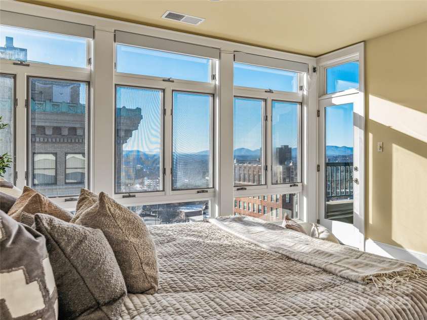 21 Battery Park Avenue, Asheville, NC 28801.  MLS# CAR4322706, YatesRealty ID 8540. Primary suite- motorized blinds and balcony access